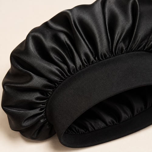 Close-up of black satin bonnet fabric and wide stretch band
